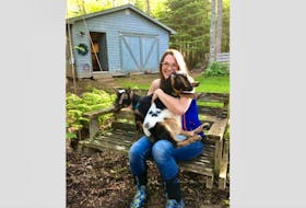 Rosalyn Ridlington Abbott enjoys some cuddles with her two miniature goats, Mary and Martha. Abbott is sad that she has to remove her goats from her property after she received a letter from lawyers for the Town of Cornwall.