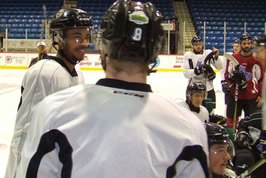 Charlottetown Islanders defenceman and captain Pierre-Olivier Joseph left, smiles as he explains a drill to defensive partner Olivier Desjardins (#8) at Isles practice Monday in Charlottetown. The Isles host the Blainville-Boisbriand Armanda on Tuesday in Game 3 of the teams best-of-seven QMJHL semifinal.