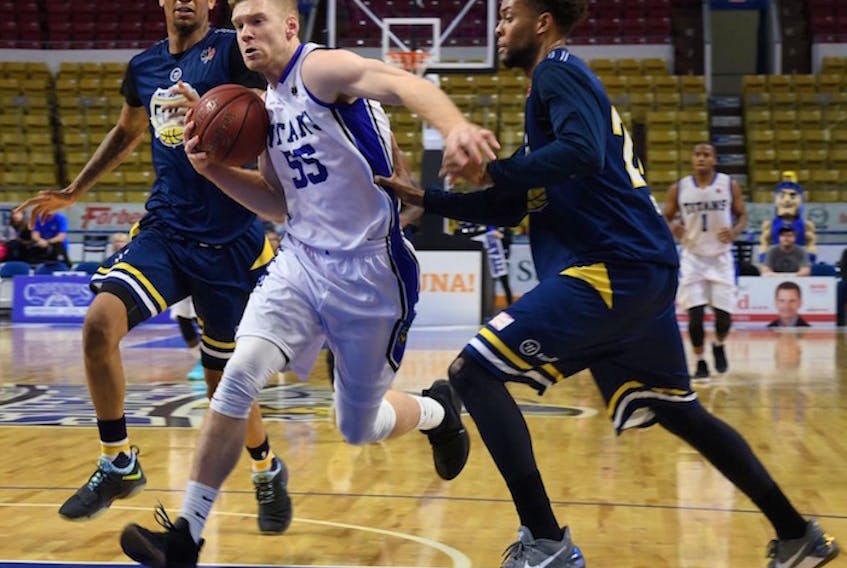 Russell Byrd (No. 55) attacks the basket as a member of the Kitcher-Waterloo Titans during a National Basketball League of Canada game against the St. John’s Edge last season.
Photo special to The Guardian by Dan Congdon