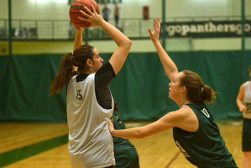 Carolina Del Santo, left, looks for a teammate to pass to while being defended by Julie Campbell during UPEI Panthers practice on Wednesday. Jason Malloy/The Guardian