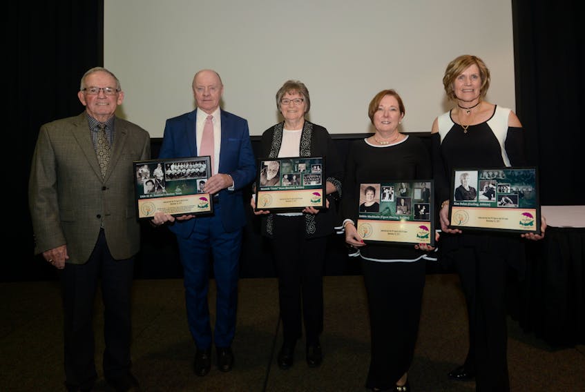 The P.E.I. Sports Hall of Fame held its 2017 induction ceremony Friday in Charlottetown. From left are Jack Kane and Vince Mulligan from the 1964-65 St. Dunstan’s Saints hockey team, Sharon Dunn, wife of the late Ken (Trixie) Dunn, Debbie MacMurdo and Kim Dolan. Jason Malloy/The Guardian
