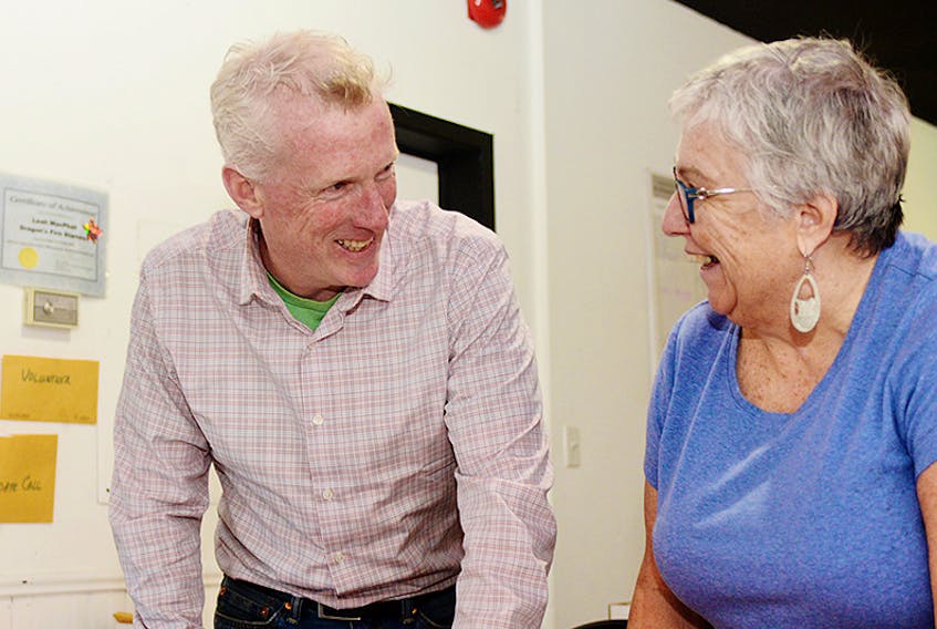 NDP candidate Mike Redmond chats with supporter Katie McInnis at his campaign headquarters on Great George Street earlier this month. Redmond, who is a vocal critic of government waste and a supporter of social justice issues, said public faith has to be restored in the provincial government.  ©THE GUARDIAN