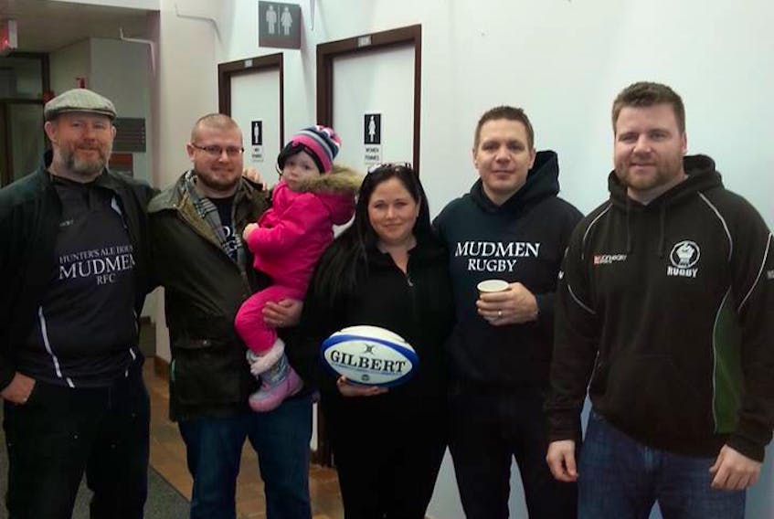 Natalie Bulger, third from right, is the centrepiece to the Hunter’s Ale House P.E.I. Mudmen rugby club. Bulger is going into the P.E.I. Rugby Union Hall of Fame for her work as an administrator, player and coach. Also pictured are, from left, Mudmen members Jason Martell and Cory Bearisto (holding his daughter Griffen), Shaun Younker and Phil Gallant.