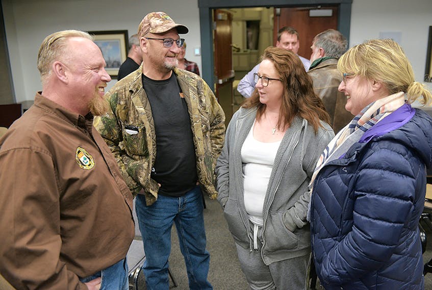 President of the P.E.I. Provincial Rifle Association Dave Hanson, from left, chats with Larry Sherren, Susan Mullen and Donna Myers following an information session on proposed changes to Canadian firearms regulations at Stratford Town Hall Tuesday.  ©THE GUARDIAN