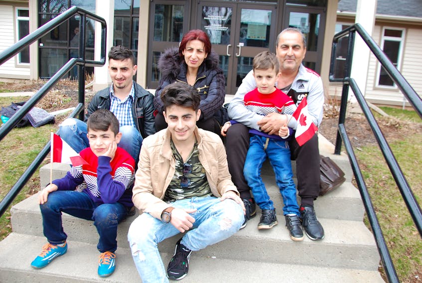 Joseph and Basma Tomas sit on the steps outside of Central Christian Church in Charlottetown with their four children: Odiss; Thomas; Andrew and Peter. The Syrian family arrived in P.E.I. to begin a new life after waiting years for the major move to be realized.