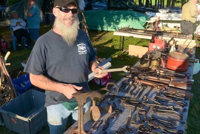 Nova Scotia resident Ken Langley shows some of the antique tools he had for sale on at the 70 Mile Coastal Yard Sale this year. Peters, along with a group of friends and family, has made attending the sale and staying in P.E.I. for the weekend an annual tradition.