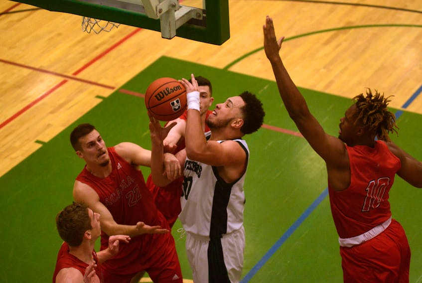 UPEI Panthers forward Vernelle Johnson comes down with the rebound while being surrounded by Acadia Axemen Saturday during Atlantic University Sport basketball action in Charlottetown. Jason Malloy/The Guardian