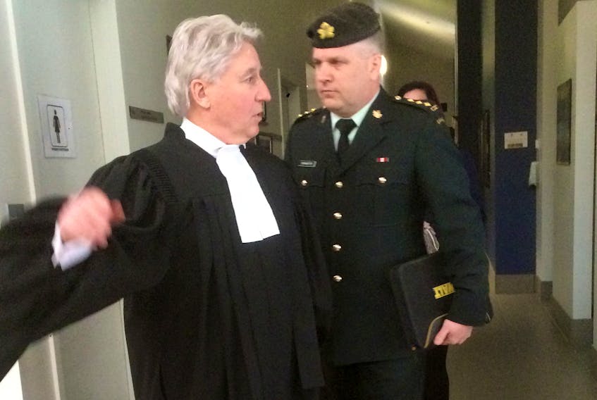 Army reserve captain Todd Bannister and his defence lawyer J.L.P.L. Boutin leave a court martial in Charlottetown on Tuesday. Bannister was found not guilty on two counts of behaving in a disgraceful manner and two counts of conduct to the prejudice of good order and discipline.