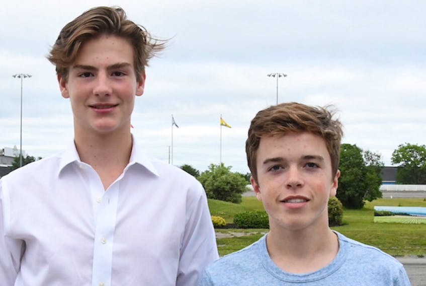 Max Dupler, left, and Charlie Friel and their parents from Columbus, Ohio, took in the races last Saturday at Charlottetown. Both boys finished two weeks at the Andrews hockey school in Charlottetown.