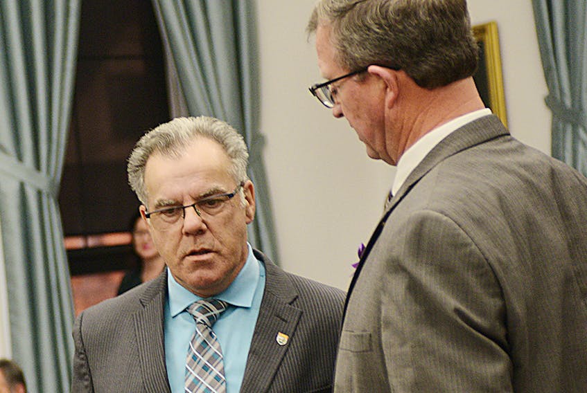 FILE PHOTO: Souris-Elmira MLA Colin Lavie, left, speaks with provincial Fisheries Minister Alan McIsaac before a recent question period during this fall’s sitting of legislature. Lavie pressed McIsaac during Tuesday’s session to take legal action to prevent the construction of a proposed treatment plant in Nova Scotia that would pump treated effluent into the Northumberland Strait.  ©THE GUARDIAN