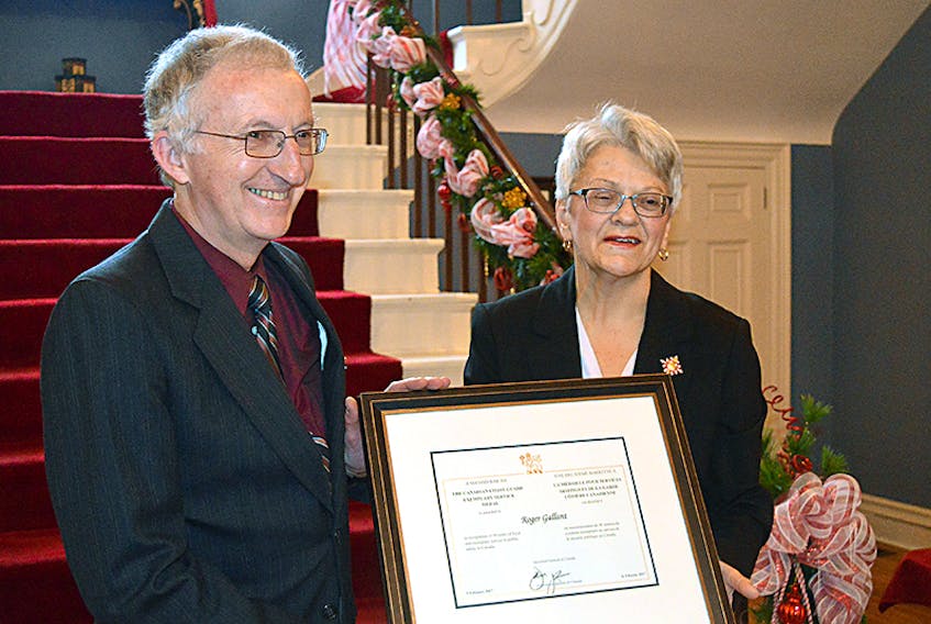 Roger Gallant of Summerside receives a Canadian Coast Guard exemplary service medal from Lt.-Gov. Antoinette Perry during a recent ceremony at Government House. He was one of eight individuals honoured.  ©THE GUARDIAN