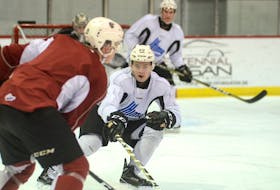 Thomas Casey, second from left, defends against Cam Askew at Wednesday’s Charlottetown Islanders practice.