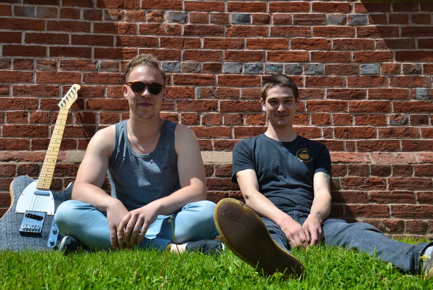 Josh Buttery, left, and Ian Gill of The Noisy Crows discuss their June 1 fundraiser for Lennon Recovery House outside during a sunny day in Charlottetown.