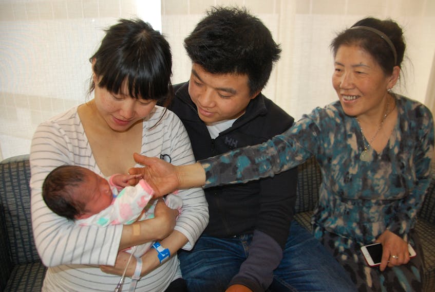 Shenyan Jiang holds her newborn daughter Kaixin Wang – the first P.E.I. baby of 2018 born early on New Year’s Day – as her husband, Tengfei Wang, and her mother, Hambing Shen, look on.