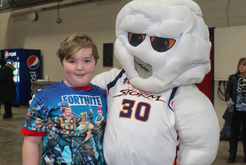 The Island Storm basketball team’s mascot greeted Kaiden Lund, 11, while he was at the tailgate party on Monday night.