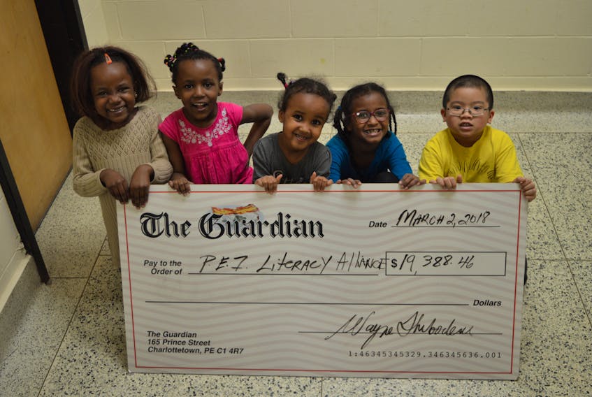 A group of children from the P.E.I. Literacy Alliance’s Ready-Set-Learn program hold a cheque for $19,388.46 donated from the annual Raise-A-Reader fundraiser. The campaign, held every September across P.E.I. by The Guardian and Journal-Pioneer, raises funds for Island literacy programs by collecting donations in exchange for free newspapers. The Ready-Set-Learn program offers free tutoring in the summer and literacy camps on school PD days. From left, are Grace Shungaza, Tumani Shungaza, Iswaq Ahmed Shadhuke, Ifrah Ahmed Shadhuke and Aryan Gurung.