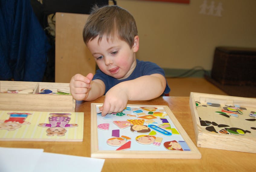 Three-year-old Oliver Rowe is fully focused on putting puzzle pieces in place at Kidz Korner Early Learning Academy in Roseneath. Education and Early Minister Jordan Brown visited the child care facility Friday to provide updates from new early years investments.