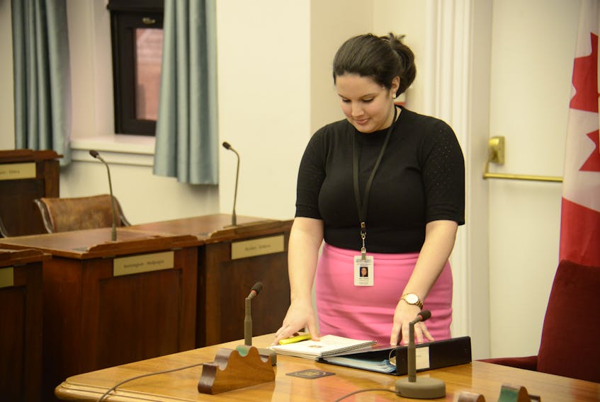 Clerk assistant Emily Doiron looks through documents on the clerk’s table in the legislative assembly before MLAs return on April 5.