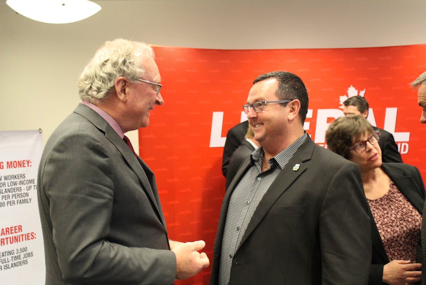 Liberal Leader Wade MacLauchlan, left, speaks with Randy Cooper, Liberal candidate for District 5 Mermaid-Stratford, during a campaign platform announcement on Wednesday, April 3.