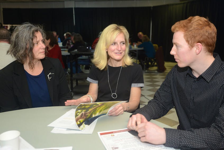 Michelle Jay, from left, Chief Health Officer Dr. Heather Morrison and Ryan Murray look over some of the results in the 2017 P.E.I. Children’s Report during a public forum at Murphy’s Community Centre Tuesday. Jay is a member of the P.E.I. Working Group for a Livable Income, which hosted the forum in partnership with the Public Health Association of N.B. and P.E.I., for which Murray is the P.E.I. representative.