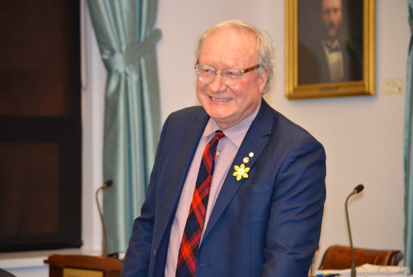 Premier Wade MacLauchlan gets ready for yesterday’s proceedings of the legislative assembly ahead of the oppositions questions about his connections to a company that received a contract to provide home care in P.E.I.