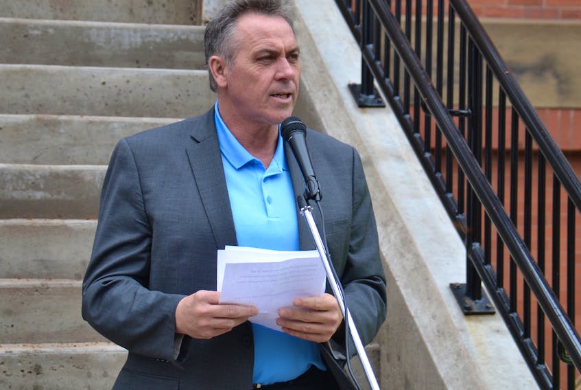 Health and Wellness Minister Robert Mitchell tells a crowd in front of the Coles Building in Charlottetown Saturday that the registered health professionals act will be proclaimed this summer.
