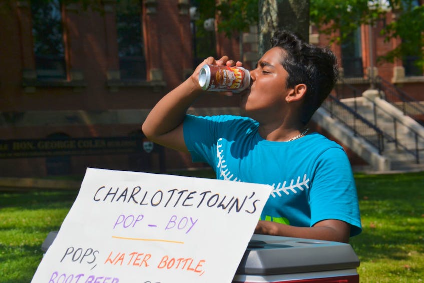Karthik Christo takes a swig of root beer beside Richmond Street in Charlottetown. The Charlottetown Pop Boy is typically selling pop in front of the George Coles building on any sunny afternoon this summer.