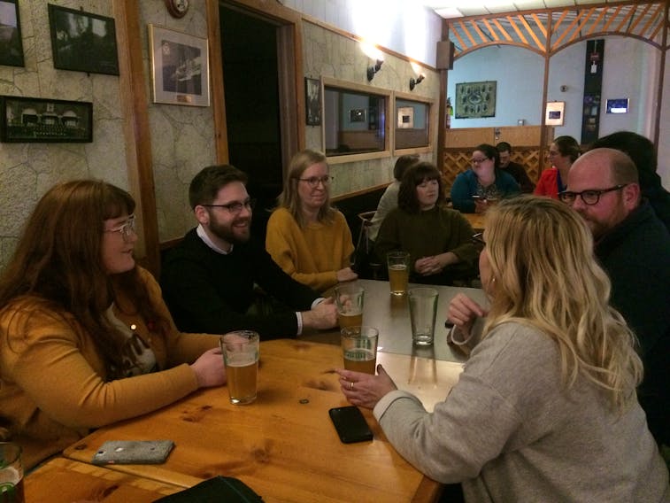 Voters, from left, Aimee Power, Naill Stanley, Eileen Conboy, Caitlin Power, Phil Homburg and Tracey Flynn discuss politics at the Charlottetown Firefighters Club waiting while waiting for Monday’s municipal election results.