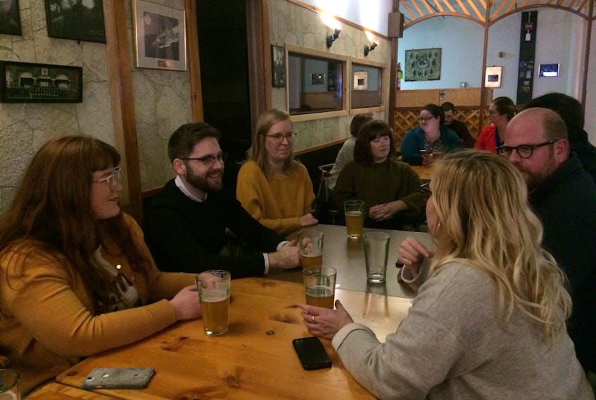 Voters, from left, Aimee Power, Naill Stanley, Eileen Conboy, Caitlin Power, Phil Homburg and Tracey Flynn discuss politics at the Charlottetown Firefighters Club waiting while waiting for Monday’s municipal election results.