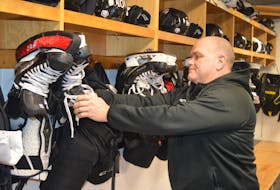 Charlottetown Islanders assistant coach Guy Girouard adjusts a pair of skates in the team’s dressing room at Eastlink Centre on Monday. The existence of the major junior hockey team and the pro basketball Island Storm makes a new arena project ineligible for federal government funding.