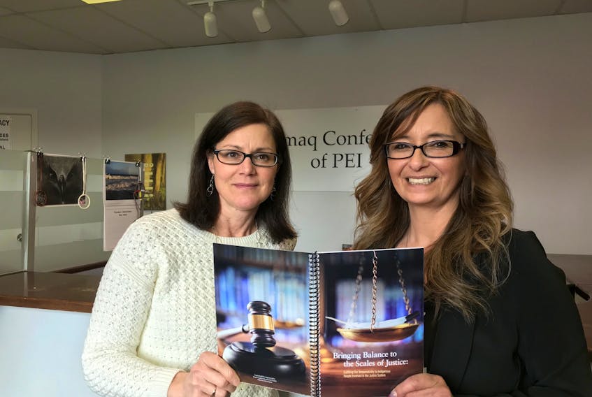 Lori St. Onge, director of Indigenous justice, and Sheri Bernard, Indigenous justice co-ordinator at the Mi’kmaq Confederacy of P.E.I., hold up a copy of a recently released resource guide.