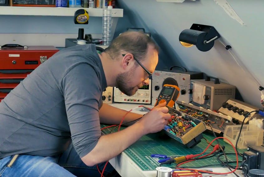 Thomas Mears repairs some vintage electronic equipment in a screenshot taken from one of Wrong Horse Productions’ most recent videos. The video, which describes how Mears’ passion was passed down from his father, is part of the “8 Stories from Prince Edward Island” series.
