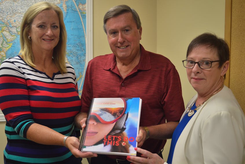 The national Canada Games bid committee will be on P.E.I. Sept. 19-20 to further assess the province’s ability to host the 2023 Canada Winter Games. The local bid committee, from left, Heather Howatt, marketing, Wayne Crew, co-chairman, and Edna Flood, bid manager, have put together various bid books like this one the national committee will be looking at. It contains information, including how the local committee plans on handling challenges such as housing, feeding and transportation.