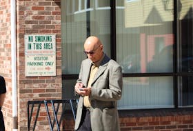 Former high school music teacher Roger Jabbour stands outside the provincial courthouse in Charlottetown Friday after a judge found him guilty of three sex offences.
