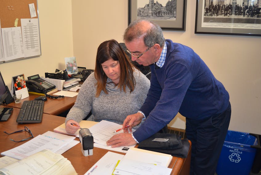 Charlottetown Mayor Philip Brown goes over some paperwork with Jill Stewart, his executive assistant, Friday at City Hall. His first day on the job consisted of two seniors’ socials and preparing for council’s first public monthly meeting on Monday night.