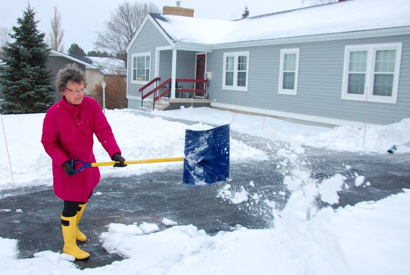 Joyce Gaudet of Charlottetown shovels her driveway on Goodwill Avenue Thursday. She said the shovelling was just a warm-up to some stationary cycling.