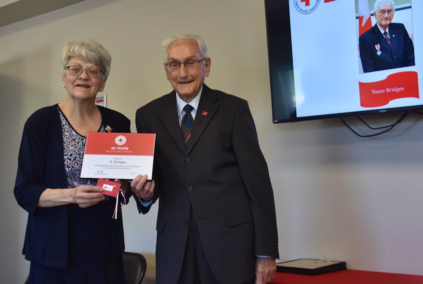 Vance Bridges accepts his award for 40 years of service with P.E.I.’s division of the Canadian Red Cross from Lt.-Gov. Antoinette Perry at the Red Cross Island branch first aid and CPR centre in Charlottetown on Saturday.