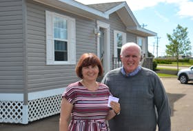 Heather Doran and Myron Yates of Big Brothers Big Sisters of Canada are shown in front of this year’s Dream Cottage with the winning ticket. The winners, Will and Marie MacPhail, live in Thompson, Man., but own land on P.E.I.