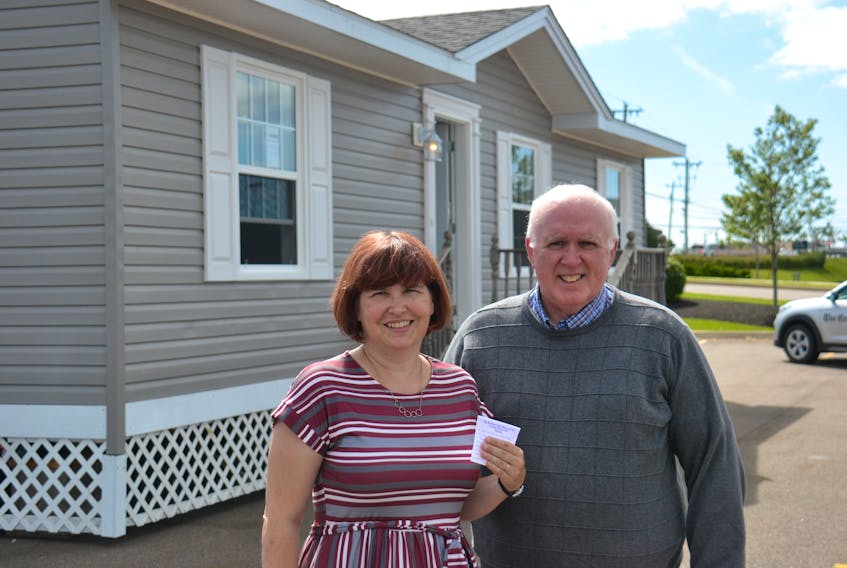 Heather Doran and Myron Yates of Big Brothers Big Sisters of Canada are shown in front of this year’s Dream Cottage with the winning ticket. The winners, Will and Marie MacPhail, live in Thompson, Man., but own land on P.E.I.