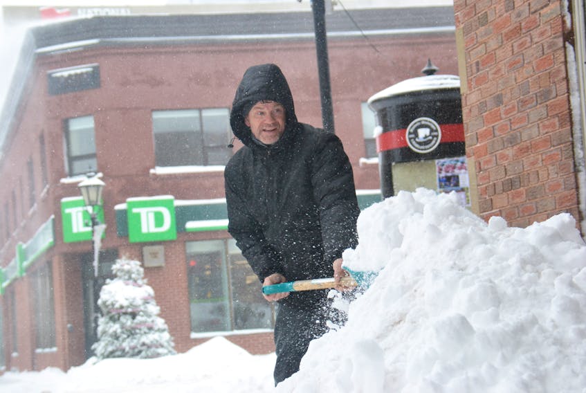 Billy Mitchell, the manager of the building on 187 Queen St. in Charlottetown, clears up the snow from another storm on Wednesday, Jan. 9, 2019.