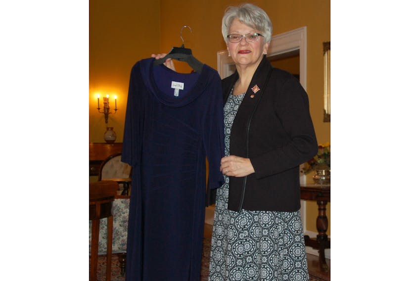 Lt.-Gov. Antoinette Perry holds up the outfit she plans to wear Thursday for her audience with the Queen at Buckingham Palace in London. She describes the Joseph Ribkoff sheath dress as understated but extremely comfortable – just plain straight down with a very slight cowl neck.