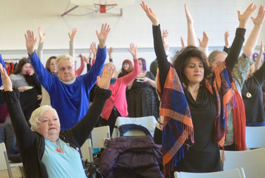 Island women take part in a chair yoga session during an event celebrating International Women's Day in Charlottetown Friday.