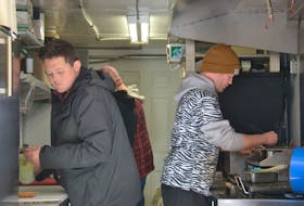 It’s business as usual on Tuesday for Nimrods’ and co-owners Mikey Wasnidge, left, and Jesse Clausheide, shown at work in their truck’s kitchen at its current location on the corner of Allen Street and St. Peters Road in Charlottetown.