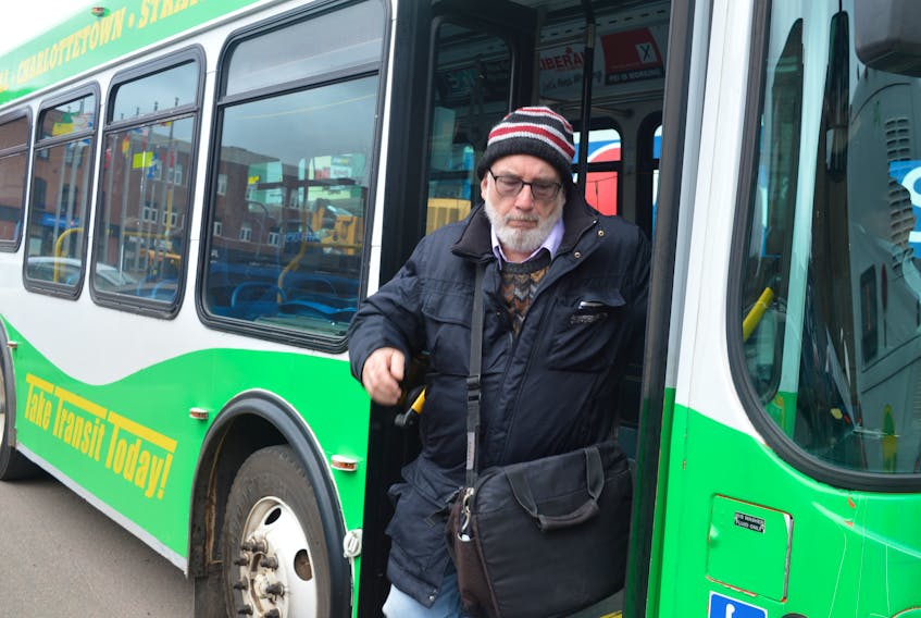 A passenger gets off the bus on Grafton Street in Charlottetown Thursday. The city is launching a six-month pilot project this month that will see the transit service expand in terms of routes and timing.