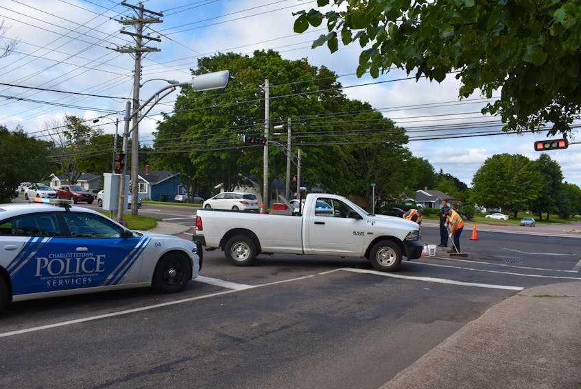 City Public Works clean up the scene of an accident this morning at the corner of North River Road and Belvedere Avenue as Charlottetown city police navigate traffic. An ambulance just left the scene.