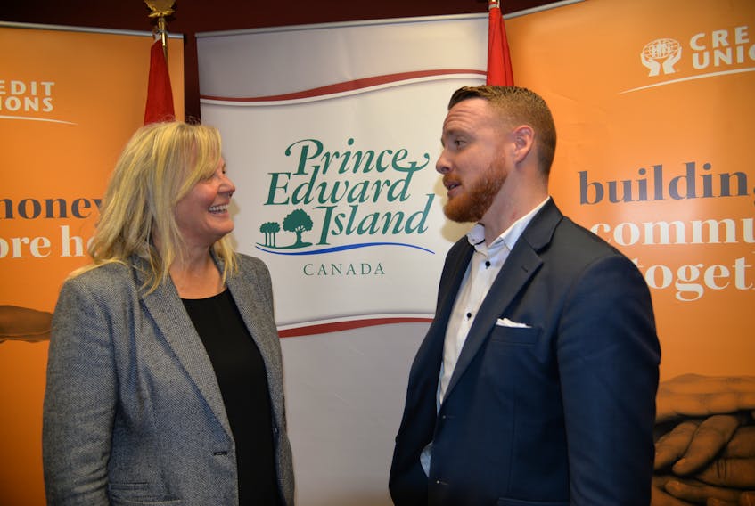 Kim Reddin, owner and mortgage broker with CENTUM Mortgage Partners Inc., and Alex Youland, a member of Charlottetown Youth Matters, and discuss the down payment assistance program at an announcement on Tuesday, Oct. 9, 2018.