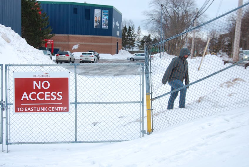 A passerby climbs the hill to go around the new gate in front of Eastlink Centre in Charlottetown last Friday. The arena and Red Shores teamed up to erect the gate to block pedestrians and traffic from accessing the Red Shores’ shipping and receiving area. It was recently identified as a safety and liability issue.