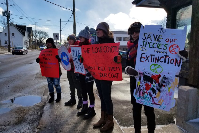 Protesters hold signs outside of Island Activewear on Saturday to oppose the store's sale of Canada Goose Jackets and the use of coyote fur and goose down in the garments. Peaceful protests were held across the country on Saturday in honour of National Anti-Fur Day, which takes place on Feb. 14. The annual event started in 1989. Shown, from left, are Daphne Azoulay, Ashley Anne Clark, Jennifer O’Brien, Sky Ford and Haley Michaud.