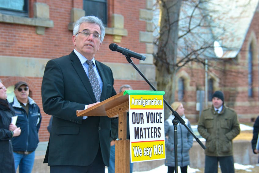 Communities Minister Richard Brown speaks to protesters outside the legislature in Charlottetown Tuesday afternoon.