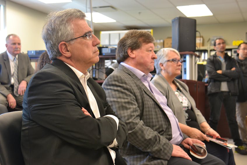 Environment Minister Richard Brown, left, waits with Charlottetown Mayor Clifford Lee and Transportation Minister Paula Biggar during a news conference at Holland College Friday announcing details of P.E.I,’s climate change action plan.
